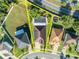 Aerial view of a house with a pool, solar panels, and well-maintained landscaping in a suburban neighborhood with mature trees at 5273 Sunset Canyon Dr, Kissimmee, FL 34758