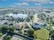 Aerial view of a community with a lake and suburban homes, showcasing the neighborhood's layout and proximity to amenities at 5273 Sunset Canyon Dr, Kissimmee, FL 34758