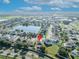 Aerial photo of neighborhood with lake, school, and nearby amenities and a red pin identifying a property's location in the community at 5273 Sunset Canyon Dr, Kissimmee, FL 34758