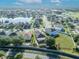 Aerial view of residential area featuring a pond, and well-spaced houses with manicured lawns, reflecting a peaceful neighborhood setting at 5273 Sunset Canyon Dr, Kissimmee, FL 34758
