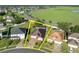 An aerial view of the home highlighted with a yellow border showing property lines at 5273 Sunset Canyon Dr, Kissimmee, FL 34758