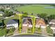 An aerial view of the home highlighted with a yellow border showing property lines at 5273 Sunset Canyon Dr, Kissimmee, FL 34758