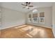 Bright bedroom featuring three windows, a ceiling fan, and light neutral paint at 5273 Sunset Canyon Dr, Kissimmee, FL 34758