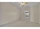 This bedroom features a ceiling fan, window with backyard view, and neutral carpet at 5273 Sunset Canyon Dr, Kissimmee, FL 34758