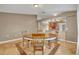 Open dining room featuring a round table, basic chairs and a view into the kitchen at 5273 Sunset Canyon Dr, Kissimmee, FL 34758