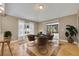 Dining area with a modern table, four chairs, and sliding doors leading to the outside at 5273 Sunset Canyon Dr, Kissimmee, FL 34758