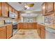 Kitchen featuring stainless appliances, granite counters and wood cabinets in an open layout at 5273 Sunset Canyon Dr, Kissimmee, FL 34758