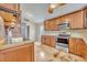 Kitchen features stainless steel appliances, wood cabinets, a sink and painted concrete floors at 5273 Sunset Canyon Dr, Kissimmee, FL 34758