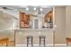 Open kitchen design with breakfast bar, wood cabinets, granite counters and stainless appliances at 5273 Sunset Canyon Dr, Kissimmee, FL 34758