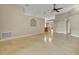 Expansive living room with a neutral color palette, archways, and seamless flow into the dining area at 5273 Sunset Canyon Dr, Kissimmee, FL 34758