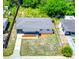 Aerial view of a well-maintained property with landscaped front yard and ample green space at 5513 Riordan Way, Orlando, FL 32808