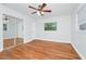 Bright bedroom featuring a ceiling fan, hardwood floors, and a mirrored closet at 5513 Riordan Way, Orlando, FL 32808