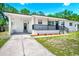 Charming one-story home featuring a covered porch, black railings, and well-maintained landscaping at 5513 Riordan Way, Orlando, FL 32808
