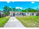 Inviting one-story home featuring a black metal railing and a well-manicured lawn at 5513 Riordan Way, Orlando, FL 32808