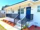 Welcoming front porch with decorative black railings and a bright blue door at 5513 Riordan Way, Orlando, FL 32808