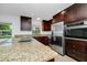 Modern kitchen with stainless steel appliances, granite countertops, and custom cabinetry at 5513 Riordan Way, Orlando, FL 32808