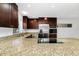 Spacious kitchen with granite countertops, stainless steel appliances, and dark wood cabinetry at 5513 Riordan Way, Orlando, FL 32808