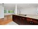 Open kitchen with granite countertops, stainless steel appliances, and hardwood floors at 5513 Riordan Way, Orlando, FL 32808