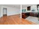Inviting open-concept living room and kitchen showcasing hardwood floors and granite countertops at 5513 Riordan Way, Orlando, FL 32808