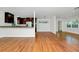 Spacious living room featuring hardwood floors, white walls, and an open floor plan into the kitchen at 5513 Riordan Way, Orlando, FL 32808