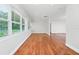 Bright living room with ample windows and hardwood floors, flowing into an open kitchen area at 5513 Riordan Way, Orlando, FL 32808