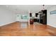 Open-concept living room and kitchen with beautiful hardwood floors and stainless steel appliances at 5513 Riordan Way, Orlando, FL 32808