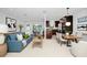 Staged living and dining area showcasing open floor plan, modern decor, and ample natural light at 5513 Riordan Way, Orlando, FL 32808