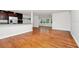 Open-concept living space with hardwood floors and an adjacent kitchen area at 5513 Riordan Way, Orlando, FL 32808
