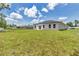 Lush grassy backyard with neighboring homes and a partial view of a parked vehicle at 586 Marion Oaks Trl, Ocala, FL 34473