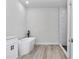Modern bathroom featuring a soaking tub, walk-in shower and wood-look floors at 586 Marion Oaks Trl, Ocala, FL 34473