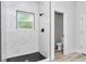 Bathroom featuring walk-in shower with black accents and black and white tile flooring at 586 Marion Oaks Trl, Ocala, FL 34473