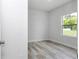 A light-filled bedroom with light wood flooring, a window overlooking a private back yard at 586 Marion Oaks Trl, Ocala, FL 34473