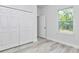 Bedroom featuring bi-fold closet doors, light wood flooring, and a window at 586 Marion Oaks Trl, Ocala, FL 34473