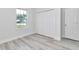 Bedroom featuring light wood flooring, a window, and a closet with bi-fold doors at 586 Marion Oaks Trl, Ocala, FL 34473