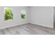 A light bedroom with two windows overlooking the lush backyard landscape at 586 Marion Oaks Trl, Ocala, FL 34473
