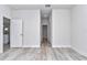 Spacious empty bedroom featuring wood-look flooring, an open doorway and a view to the hallway at 586 Marion Oaks Trl, Ocala, FL 34473