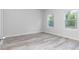 A well-lit, modern bedroom featuring light wood flooring and multiple windows at 586 Marion Oaks Trl, Ocala, FL 34473