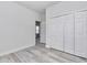 Bedroom featuring light wood flooring, bi-fold closet doors, and a view to the hall at 586 Marion Oaks Trl, Ocala, FL 34473