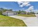 The driveway leads up to a modern house with a two-car garage and manicured lawn. A smaller house is next door at 586 Marion Oaks Trl, Ocala, FL 34473