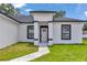 Inviting front exterior featuring a manicured lawn and a charming entrance that enhances the home's curb appeal at 586 Marion Oaks Trl, Ocala, FL 34473