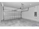 Spacious two car garage with automatic door and concrete flooring, ready for parking and storage at 586 Marion Oaks Trl, Ocala, FL 34473