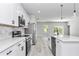 Bright kitchen featuring white cabinets, stainless appliances, and island with a sink at 586 Marion Oaks Trl, Ocala, FL 34473