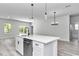 Bright, open kitchen with a large island, pendant lights and stainless steel dishwasher at 586 Marion Oaks Trl, Ocala, FL 34473