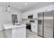 Modern kitchen featuring white cabinets, stainless steel appliances, and a center island with a sink at 586 Marion Oaks Trl, Ocala, FL 34473