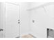 Clean laundry room featuring a white door, wire shelf and utility sink at 586 Marion Oaks Trl, Ocala, FL 34473