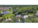 An aerial view of a cozy home surrounded by lush landscaping and a serene pond, a peaceful retreat at 612 Heron Bay Dr, Orlando, FL 32825
