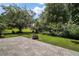 Enjoy the outdoors on this brick backyard patio with a fire pit and lush green landscaping at 612 Heron Bay Dr, Orlando, FL 32825