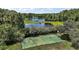 Recreational basketball court surrounded by lush greenery and a nearby lake, perfect for outdoor fun at 612 Heron Bay Dr, Orlando, FL 32825