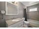 Bathroom featuring a large framed mirror, granite counters, and shower-tub combo at 612 Heron Bay Dr, Orlando, FL 32825