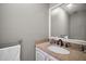 Well-lit half bathroom with granite vanity, white cabinets, and a large mirror at 612 Heron Bay Dr, Orlando, FL 32825